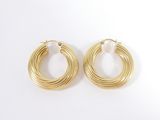 a pair of gold hoop earrings on a white background