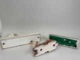 three pieces of metal on a table with a white background