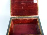 a small wooden box that is open on a white surface