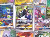 a lot of pokemon cards on display on the wall