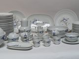 a lot of plates and bowls on the table