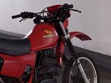 a red motorcycle that is parked in a garage