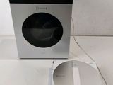 an image of a silver and black washing machine next to a white box