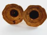 two brown vases sitting on a white surface