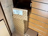 a cardboard box that is sitting on the floor next to a dresser