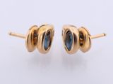 a pair of gold earrings with blue sapphire stones