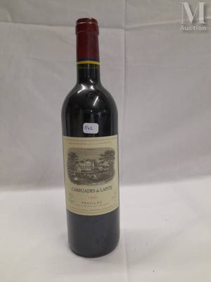 the bottle of wine is sitting on the table ready to be eaten