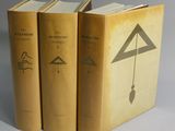 trois livres superposés sur une surface blanche