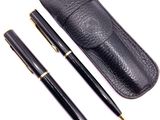 a black pen and a black case on a white background