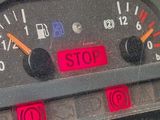 a close up of a car dashboard with a stop sign on it