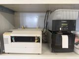 a microwave and a printer on a shelf in a room