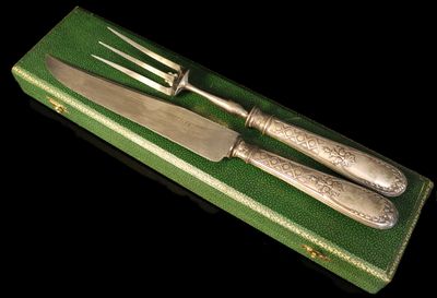 deux couteaux et une fourchette dans une boîte verte