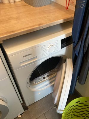 a washer and a dryer in a small room
