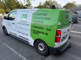 a green and white van that is parked in a parking lot