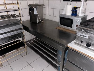 a kitchen with a stove, oven, microwave, and other appliances