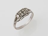an antique silver ring with a diamond set in the center