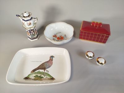 a white plate with a bird on it next to a red box