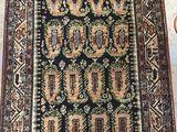 a black and red rug with a pattern on it