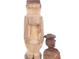 wooden figurine of a man and a child standing next to each other