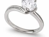 a close up of a diamond ring on a white background