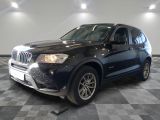 a picture of a black bmw suv parked in a garage