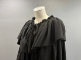 an image of a mannequin wearing a black dress