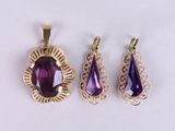 three amethorate pendants and a pendant with a tear shaped amethorate