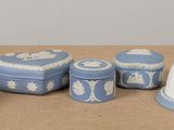 several pieces of blue and white pottery sitting on top of a table