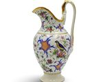 a white and blue vase with a bird on it