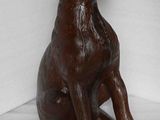 a statue of a dog that is sitting on the floor