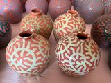 many different colored vases sitting on a table