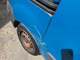 a blue van that is parked on the side of the road