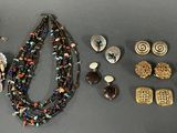 a lot of jewelry that is laying out on the table