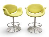 pair of yellow swivel chairs with chrome bases