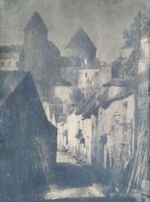 an old photo of a street with buildings and a horse