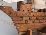 a wooden model of a pirate ship on display
