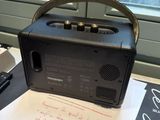 a radio sitting on top of a table next to a book