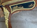 a wooden table with a blue and gold decoration on it