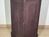 a wooden cabinet with a brown top on a tiled floor