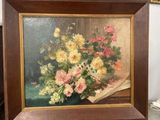 a picture of a painting of flowers in a vase on a easel