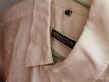 a white shirt hanging on a hanger in a closet