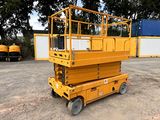 the yellow scissor is parked in front of a shipping container
