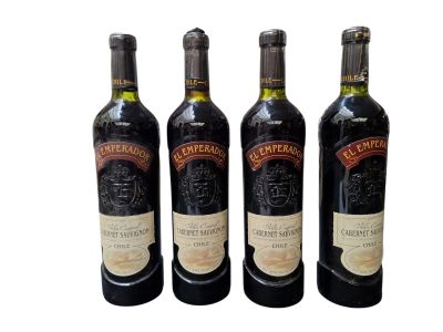 three bottles of wine sitting next to each other on a white surface