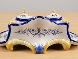a blue and white dish with a lid on a wooden table