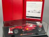 a ferrari car in a display case on a white surface