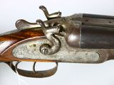 an old gun with a wooden handle on a white background