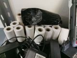 many rolls of toilet paper sitting on a desk next to a computer