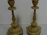 pair of antique brass candlesticks with green glass in the form of flowers