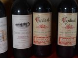 several bottles of red wine are lined up on a table