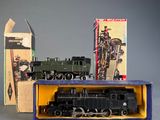 a toy train in a box next to a box of other toys